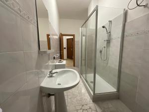 a white bathroom with a sink and a shower at Casa Sofia Trastevere in Rome