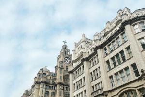 a large building with a clock tower on top of it at PENTHOUSE - LIVERPOOL City Centre & Royal Hospital Location in Liverpool