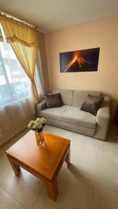 a living room with a couch and a coffee table at Departamento en Baños - Domussc in Baños