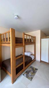 a bedroom with two bunk beds in a room at Departamento en Baños - Domussc in Baños