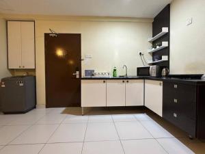 a kitchen with a sink and a refrigerator at Bayu Marina Resort 3 Bedroom in Johor Bahru