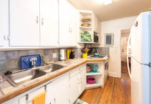 a kitchen with white cabinets and a sink at Graduations Welcome! Bayside Bungalow Close Proximity to Downtown Beaufort and Parris Island in Beaufort
