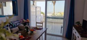 a living room with a couch and a table with flowers at Ocean View 1 bedroom in Costa Adeje in Adeje