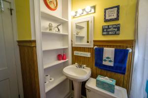 a bathroom with a sink and a toilet and a mirror at Graduations Welcome! Bayside Bungalow Close Proximity to Downtown Beaufort and Parris Island in Beaufort +58 photos