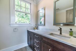 a bathroom with a sink and a mirror at Historic Home Overlooking the Beaufort River Located on Bay St - Sleeps 10 in Beaufort +52 photos