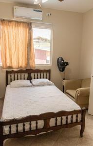 a bedroom with a bed and a window and a couch at San Alejo Zero in San Jacinto