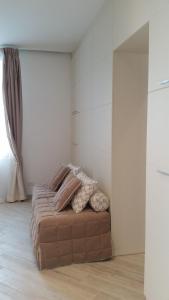 a bedroom with a brown couch in a room at Hotel Splendid in Diano Marina