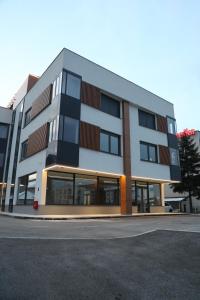 a large apartment building with a lot of windows at Moaline Apartments, free parking in Sarajevo