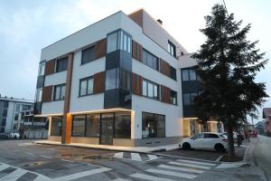 a building with a car parked in front of it at Moaline Apartments, free parking in Sarajevo