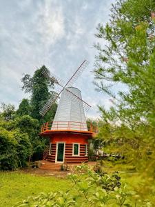 a small house with a windmill in a field at Brown Andaman Krabi in Krabi
