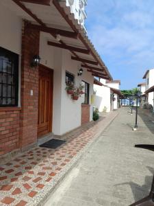 a brick building with a door on a street at Espectacular cabaña en Coveñas - Sucre, Frente al mar!!! in Coveñas