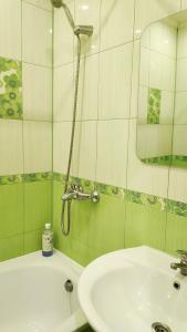 a bathroom with a sink and a shower at Дачна 37,CityRooms in Bila Tserkva