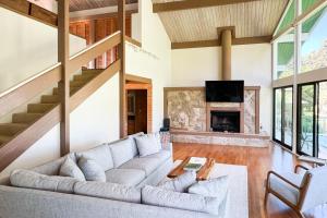 a living room with a couch and a fireplace at Hale Ho'omaha in Princeville