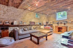 a living room with a couch and a table at Villa Boileau - Welkeys in Paris