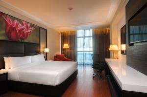 a hotel room with a bed and a television at Hilton Garden Inn Lima Surco in Lima