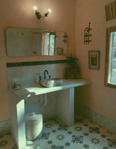 a bathroom with a sink and a mirror at Domenica Casa Hotel in La Cumbre