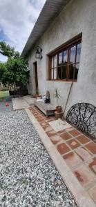 a house with a stone patio in front of it at Domenica Casa Hotel in La Cumbre