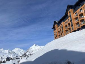 a building on top of a snow covered mountain at Luxury apartment with specticular views in Gudauri