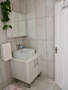 a bathroom with a sink and a mirror at 22's Company in Cape Town