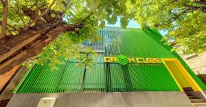 a green fence with a building in the background at Green Cube Capsule Hostel in Sofia