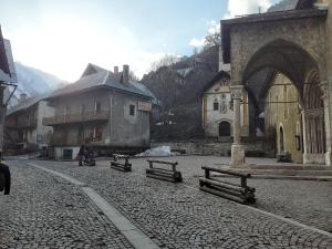 a group of benches sitting in a street next to a building at LES ECRINS in Vallouise