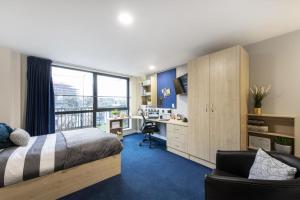 a bedroom with a bed and a desk and a window at Cosy Modern Studios at Sheffield 3 located near the University of Sheffield in Sheffield