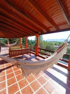 a hammock on a patio with a roof at Chalet Fer Icho in Villa Icho Cruz