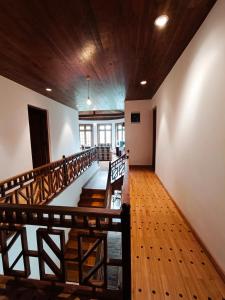a staircase in a house with a wooden ceiling at Magnolia Hideout in Nuwara Eliya