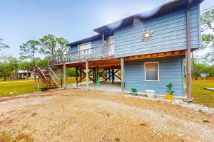 a house with a large deck on the side of it at Island Retreat in St. George Island