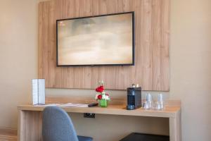 a desk in a hotel room with a flower on it at Dominium Hotel in Agadir