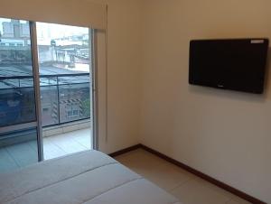 a room with a flat screen tv on the wall at TORRES DEL TUCUMAN II in San Miguel de Tucumán