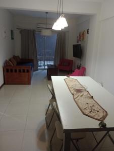 a living room with a table and a couch at TORRES DEL TUCUMAN II in San Miguel de Tucumán +2 photos