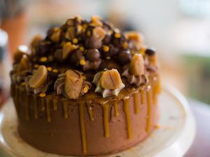 a chocolate cake with peanuts and chocolate sauce on top at The Smugglers Rest in Woolacombe