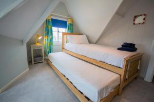 a bedroom with two bunk beds in a attic at 3 Trinity Street in Southwold