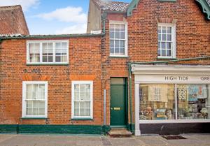 a red brick building with a high turf store at 3 Trinity Street in Southwold