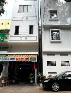 a black car parked in front of a building at Khách Sạn Nam Đô 1 in Can Tho