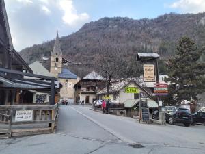 a street in a small town with a church at LES ECRINS in Vallouise