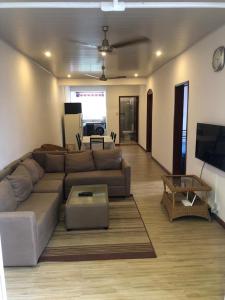 a living room with a couch and a table at Peaceful Nest in Mont Choisy in Grand Baie