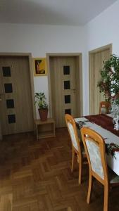 a dining room with a table and chairs and a table and chairsktop at Noclegi in Poznań +45 photos