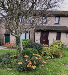 a house with a tree and flowers in front of it at 2 bed House with office in Historic Richmond in Richmond