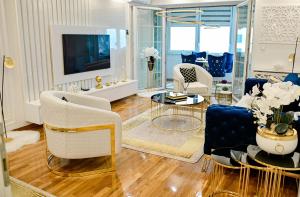 a living room with blue and white furniture at Luxury Apartment Karic FREE parking in Tuzla
