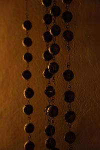a row ofadedaded necklaces on a wall at Private Apartment - the coffee apartment in Cusco