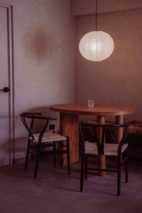a table and chairs in a room with a lamp at Private Apartment - the coffee apartment in Cusco