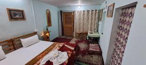 Dormitorio pequeño con cama y mesa en Leela Cottages, en McLeod Ganj