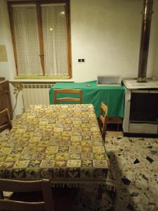 tavolo e sedie in cucina con tovaglia verde di Casa Serena a Scanno