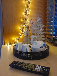 a remote control sitting on a table next to a christmas tree at Berghof Reiter in Weissbriach
