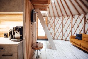 a room with a couch and a table in a yurt at Slow Flow Glamp in Rzyki