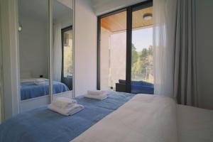 a bedroom with a large mirror and a bed at Park Residence 7 - 1 bd apartment in Tivat Center in Tivat