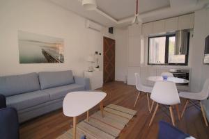 a living room with a couch and a table and chairs at Park Residence 7 - 1 bd apartment in Tivat Center in Tivat