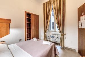 a bedroom with a bed and a large window at Hotel Giada Roma in Rome